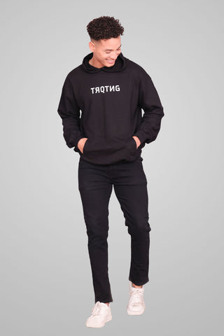 Fierce unisex oversized hoodie in classic black worn by male model, front full view