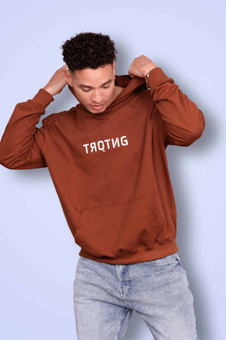 Fierce unisex oversized hoodie in mahogany color worn by male model, front full view
